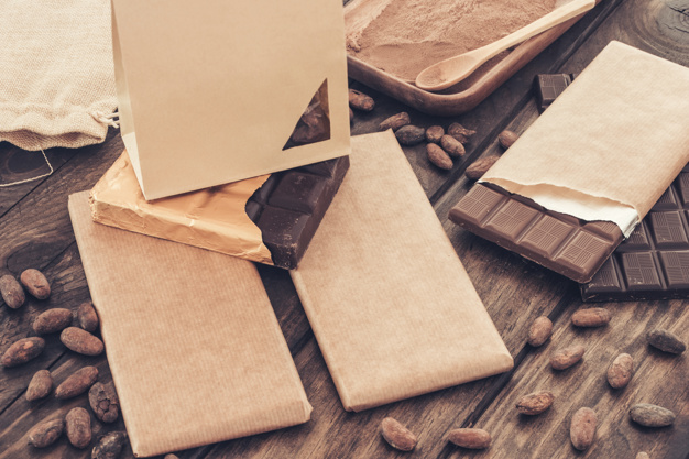 small-paper-bag-packed-chocolate-bar-with-cocoa-beans-table_23-2147873723.jpg